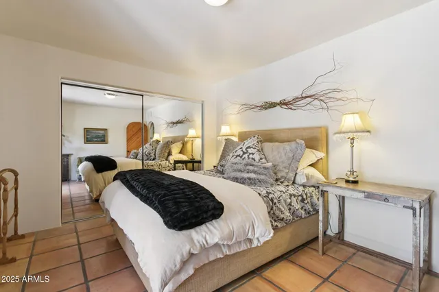 a view of a yard with plants and large trees