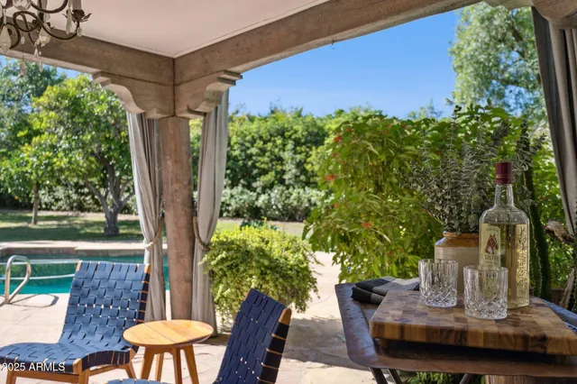 a view of a house with backyard porch and sitting area