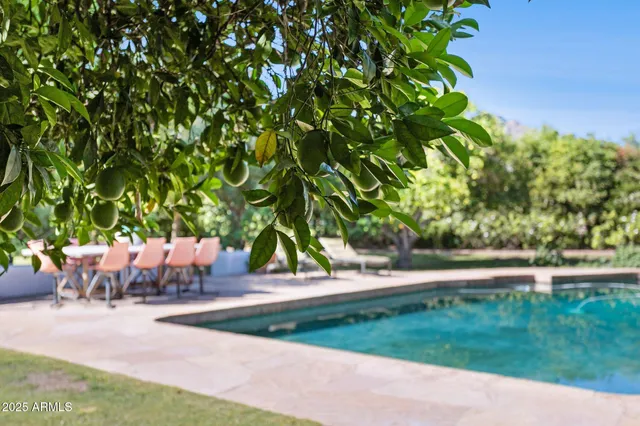 a backyard of a house with table and chairs