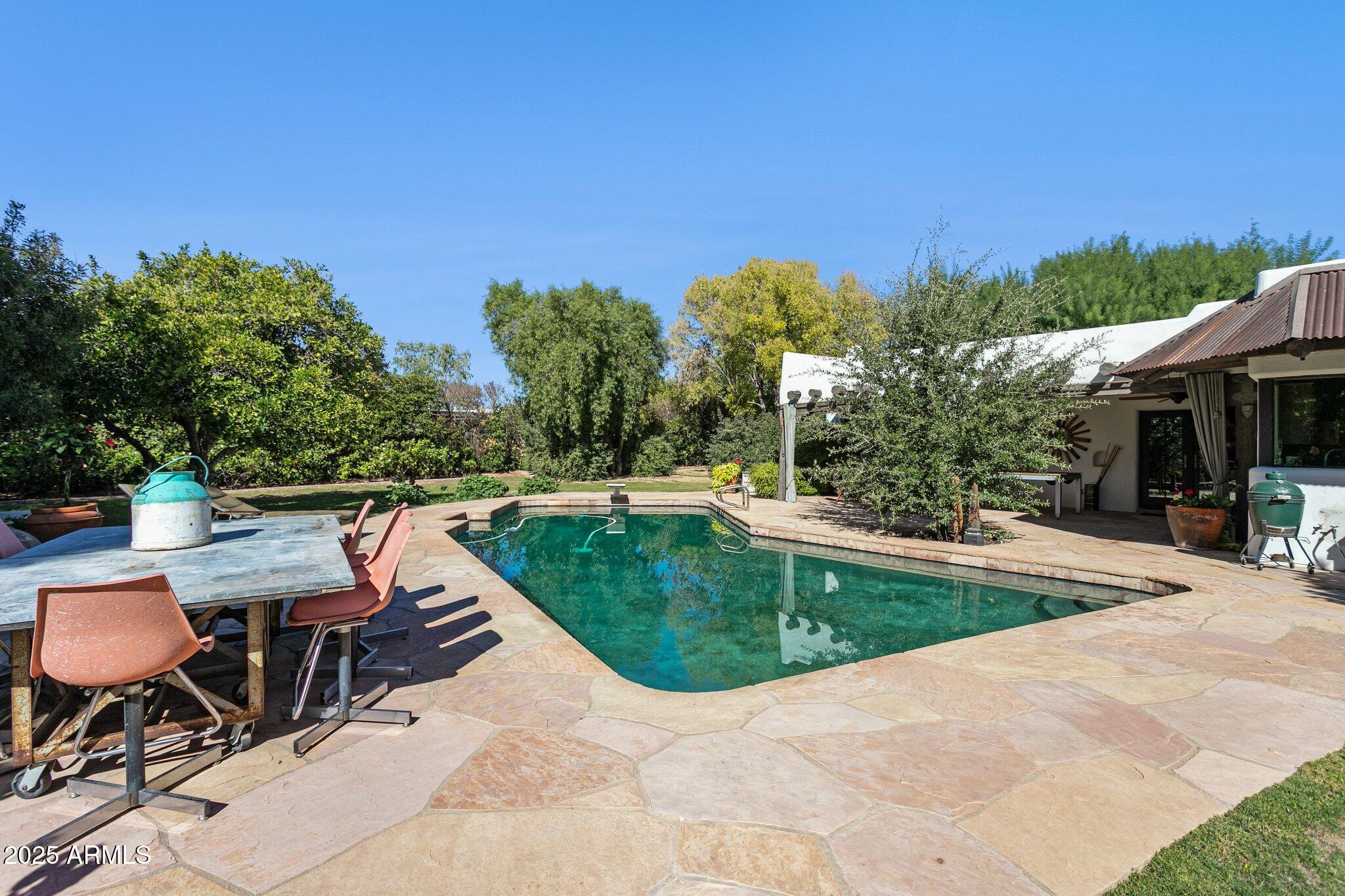 7005 East Jackrabbit Road Paradise Valley, AZ 85253 - Photo 47 of 61 a view of a swimming pool with a patio