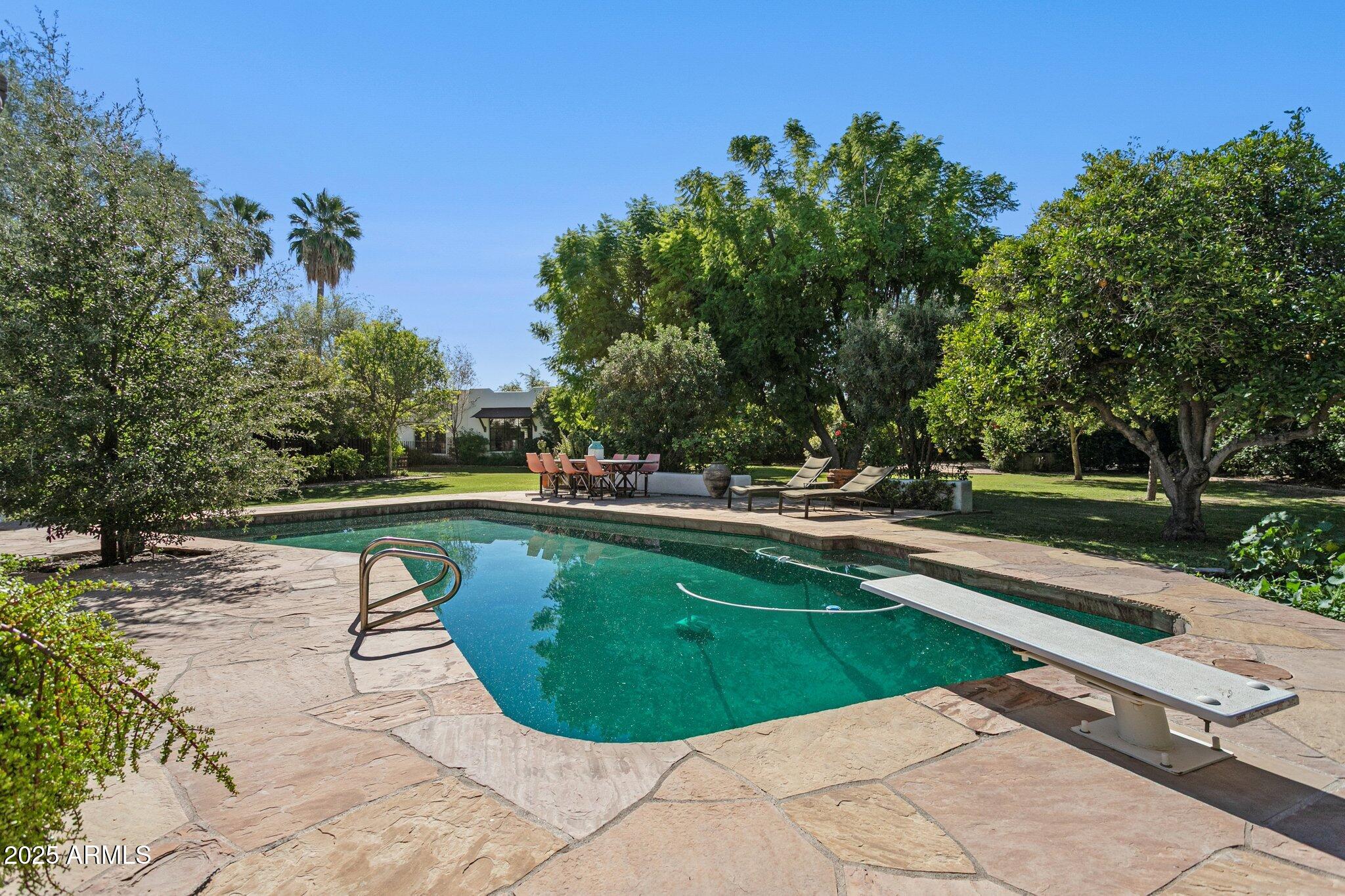7005 East Jackrabbit Road Paradise Valley, AZ 85253 - Photo 49 of 61 a view of a swimming pool with a yard