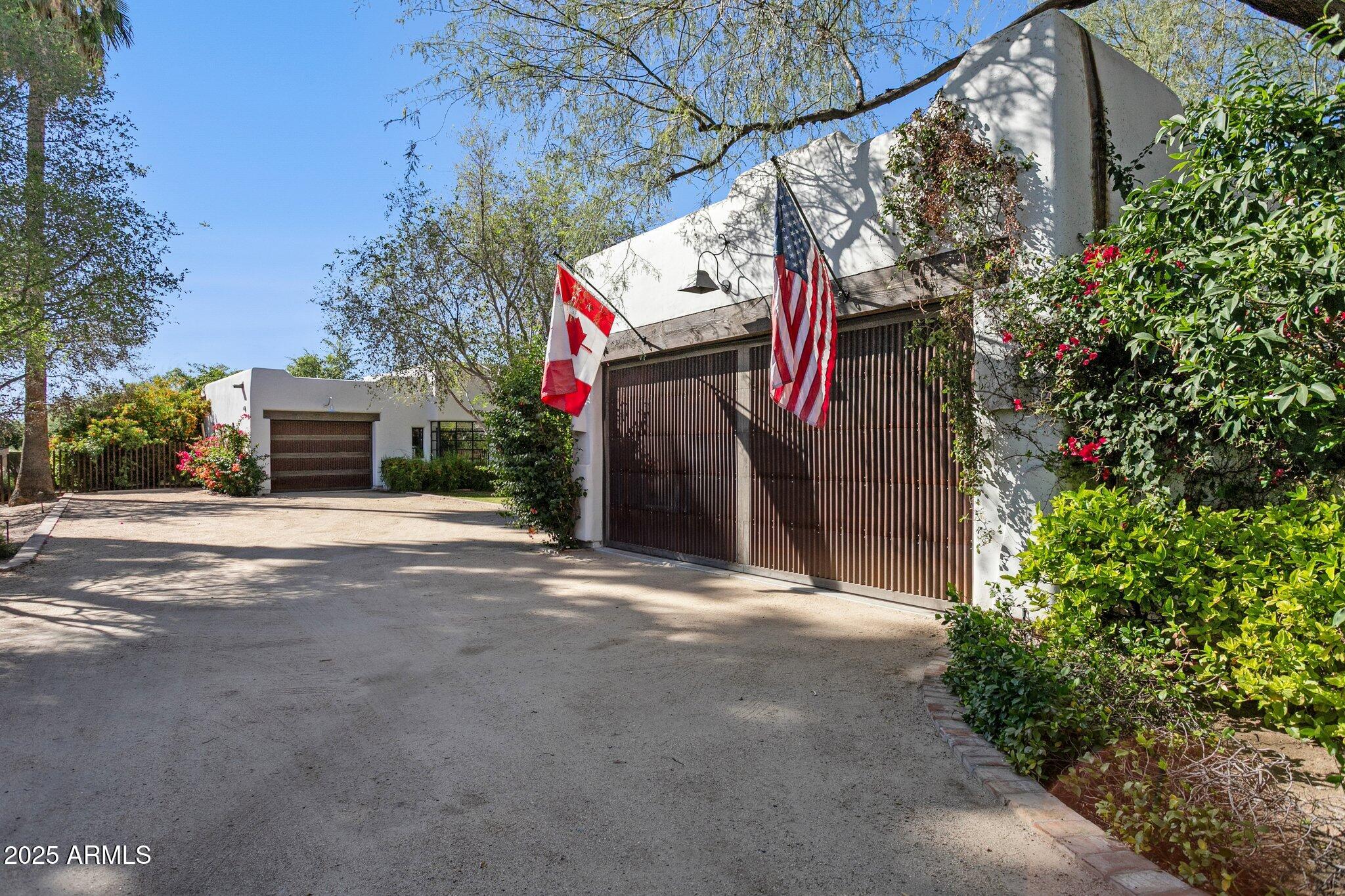 7005 East Jackrabbit Road Paradise Valley, AZ 85253 - Photo 53 of 61 a front view of a house with a street