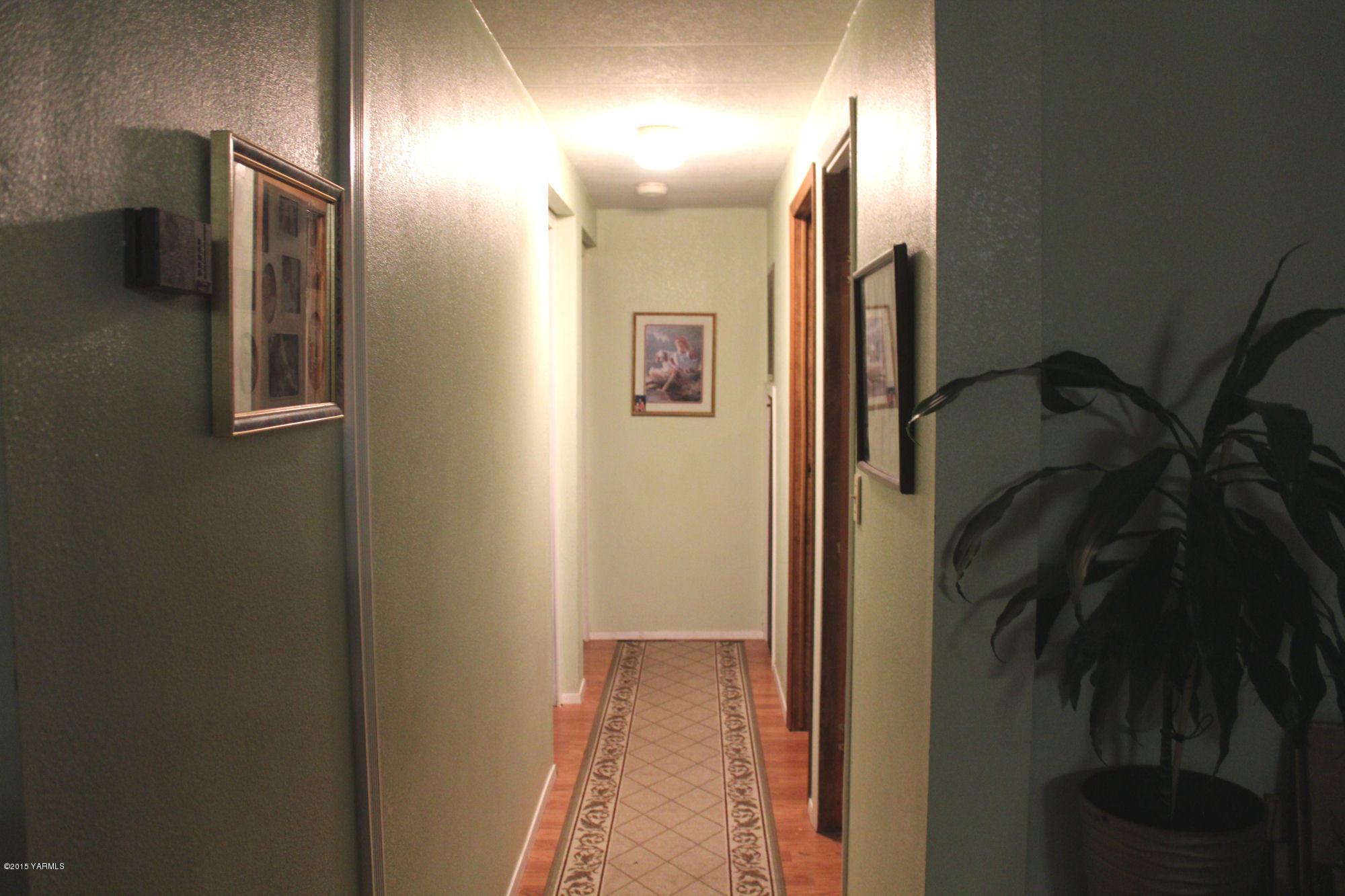 5205 Postma Road Yakima, WA 98901 - Photo 12 of 13 a view of a hallway with wooden floor