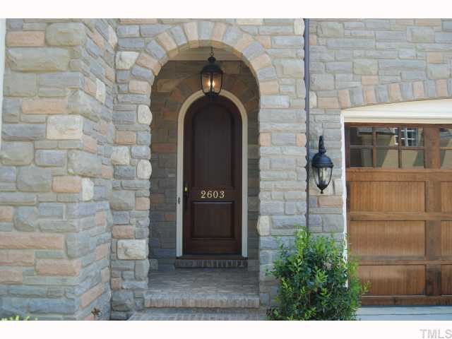2603 Graves Court Raleigh, NC 27608 - Photo 2 of 4 Arched stone front porch and arched front door add to the charm and welcome guests with a comfortable cottage-style entryway
