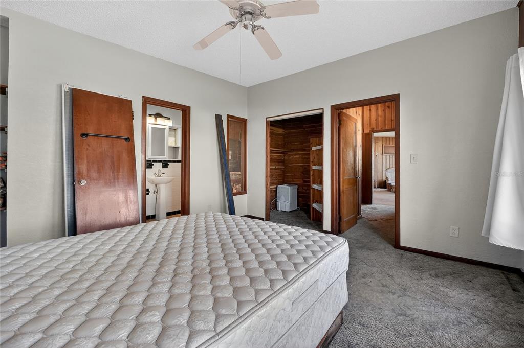 1630 Riverside Drive Daytona Beach, FL 32117 - Photo 27 of 62 a bedroom with a large bed and a chandelier