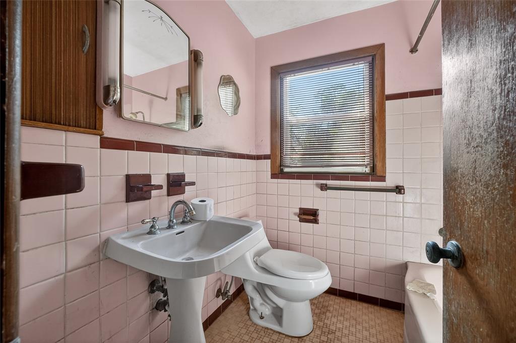 1630 Riverside Drive Daytona Beach, FL 32117 - Photo 35 of 62 a bathroom with a toilet sink and mirror