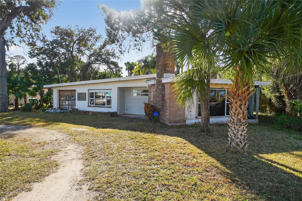 1630 Riverside Drive Daytona Beach, FL 32117 - Photo 53 of 62 a backyard of a house with yard and outdoor seating