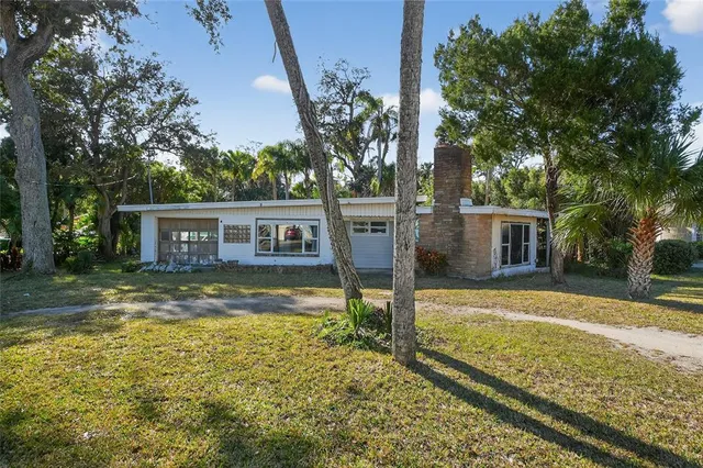 a view of backyard with swimming pool and green space