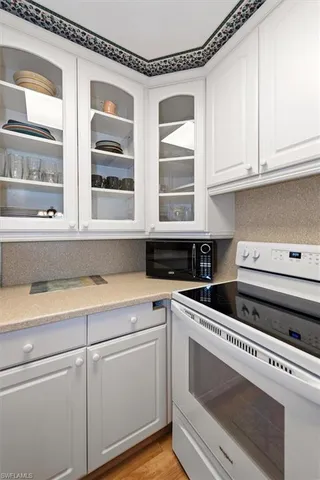 a view white cabinets and a wooden floor