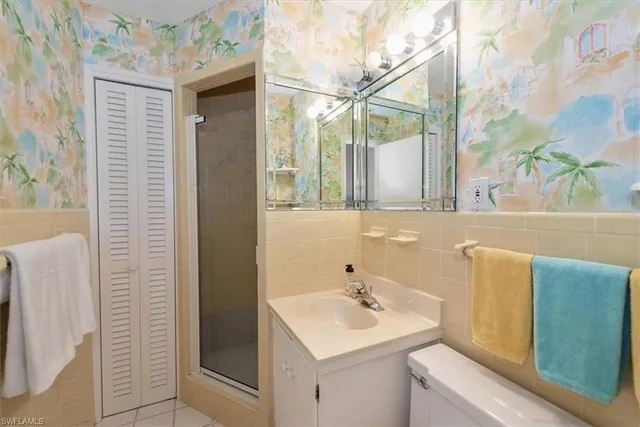 a bathroom with a sink a mirror and a shower