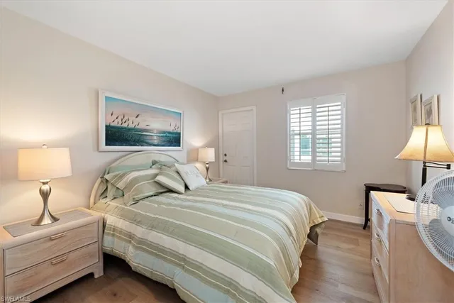 a bedroom with a bed and a lamp