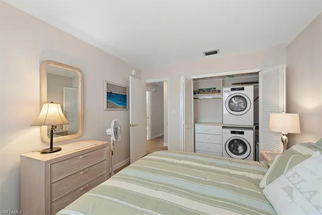 a view of a bedroom with sink and washer