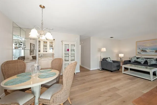 a living room with furniture a chandelier and a fireplace