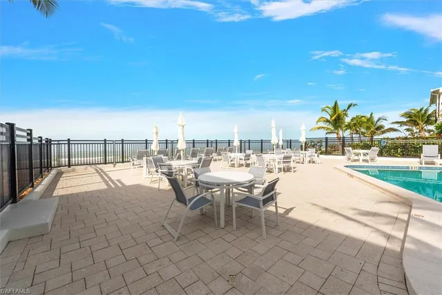 a view of a patio with dining table and chairs
