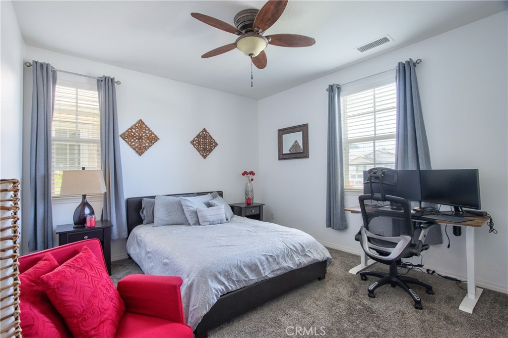 28483 Nautical Point Circle Menifee, CA 92585 - Photo 28 of 44 a bedroom with a bed and a chandelier