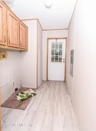 a view of a room with wooden floor and windows