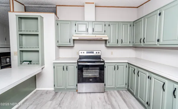 a kitchen with granite countertop a stove and a sink