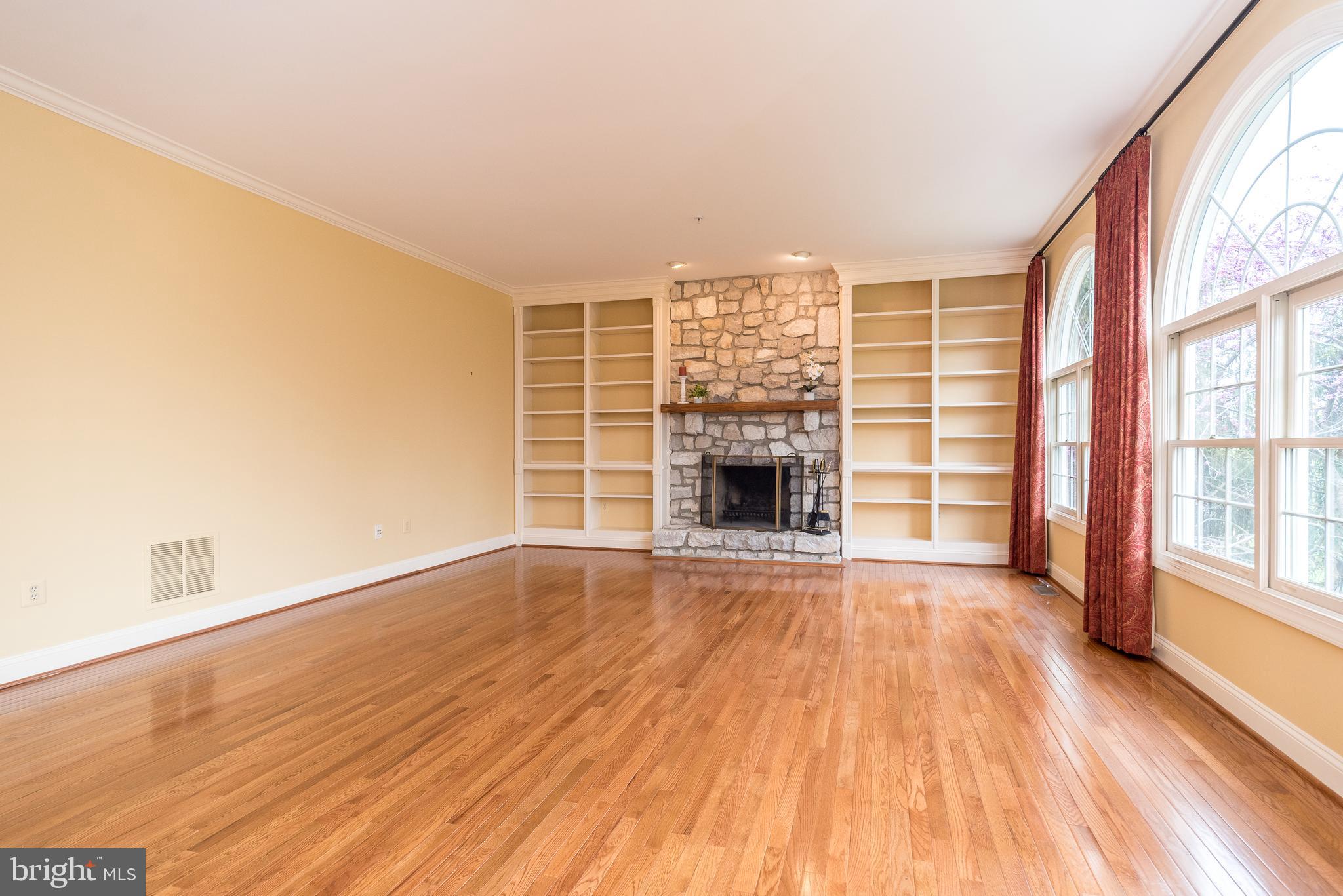 2517 Lockleigh Road Jamison, PA 18929 - Photo 18 of 72 an empty room with wooden floor fireplace and windows