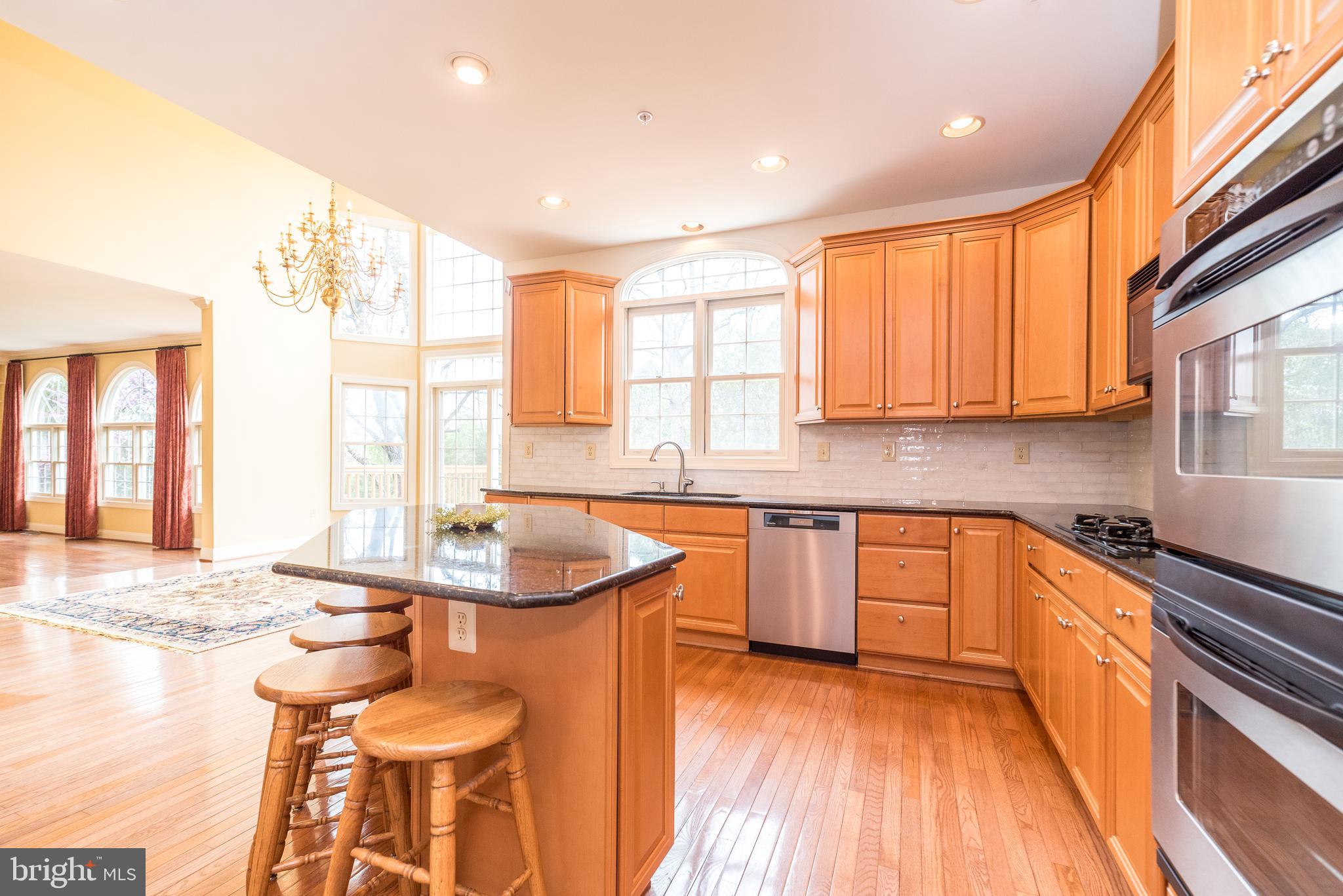 2517 Lockleigh Road Jamison, PA 18929 - Photo 24 of 72 a kitchen with stainless steel appliances granite countertop a sink a stove and a wooden cabinets