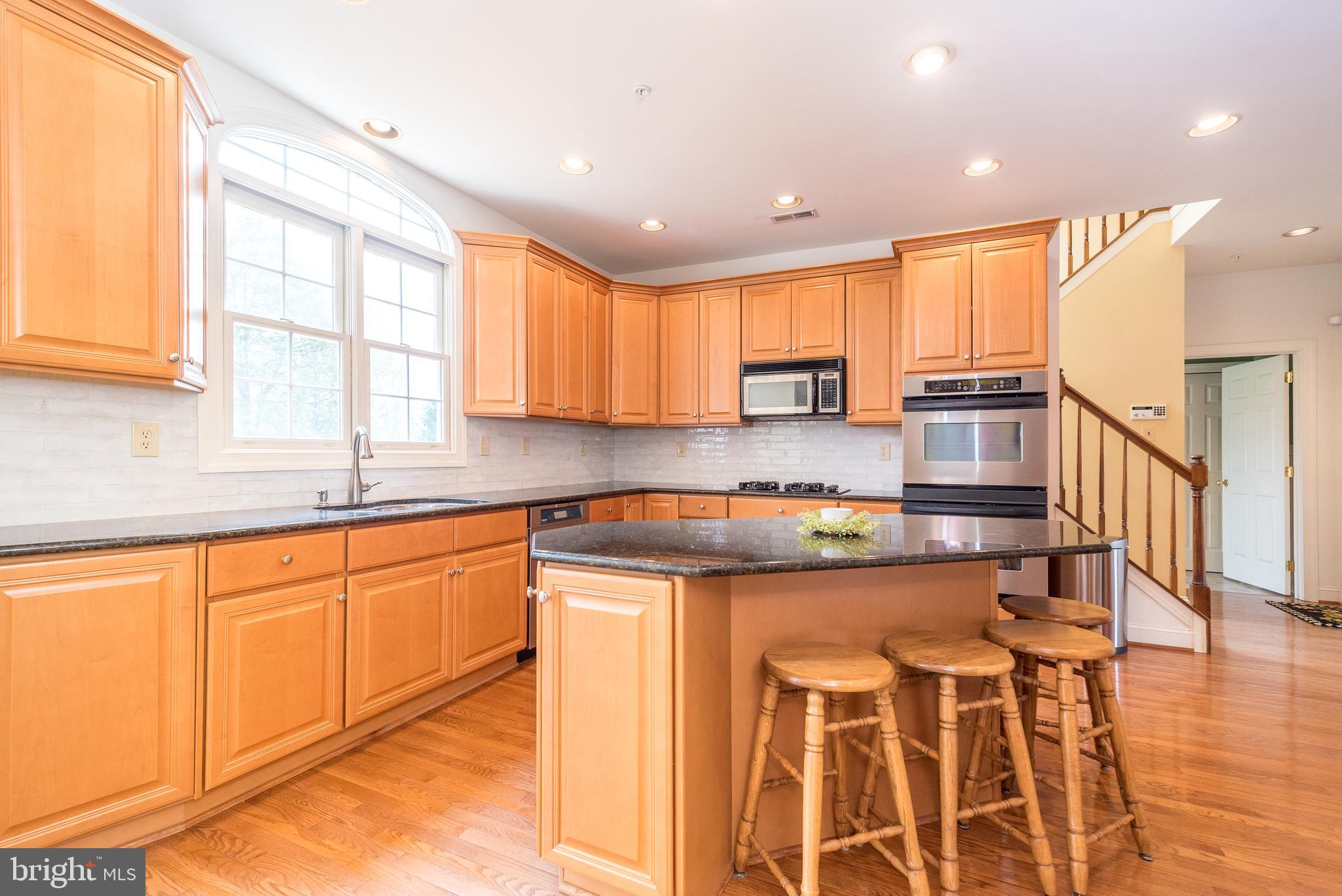 2517 Lockleigh Road Jamison, PA 18929 - Photo 26 of 72 a kitchen with stainless steel appliances granite countertop a stove a sink and a microwave