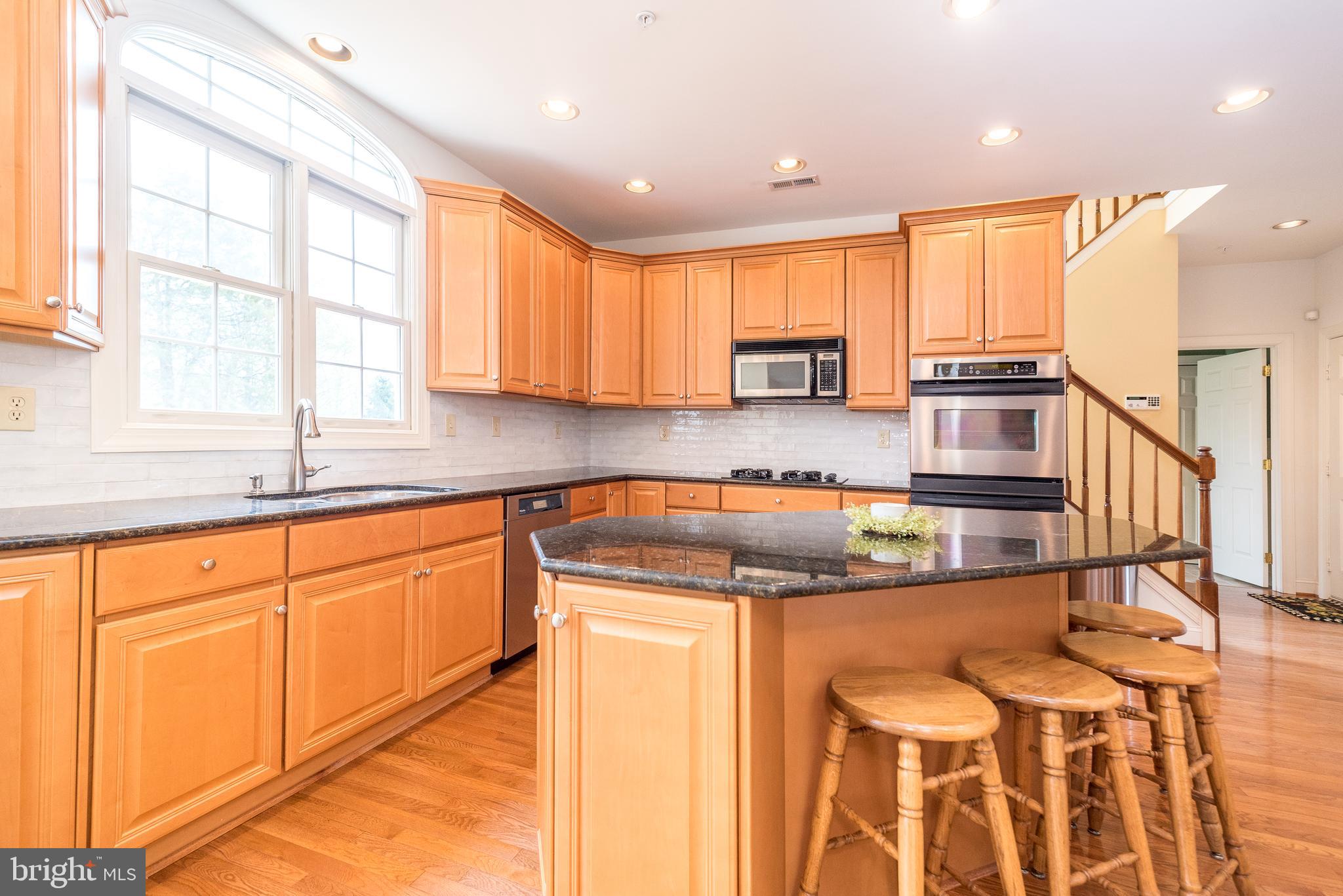 2517 Lockleigh Road Jamison, PA 18929 - Photo 27 of 72 a kitchen with stainless steel appliances granite countertop a sink a stove and a refrigerator