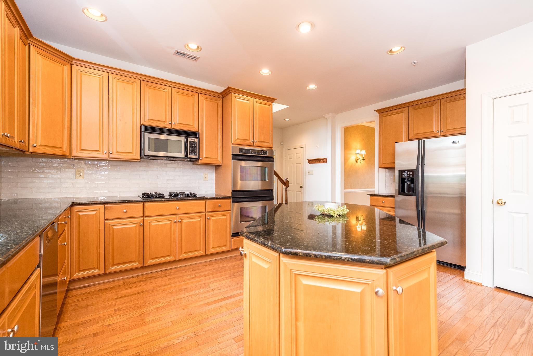 2517 Lockleigh Road Jamison, PA 18929 - Photo 29 of 72 a kitchen with stainless steel appliances granite countertop a sink a stove and a refrigerator
