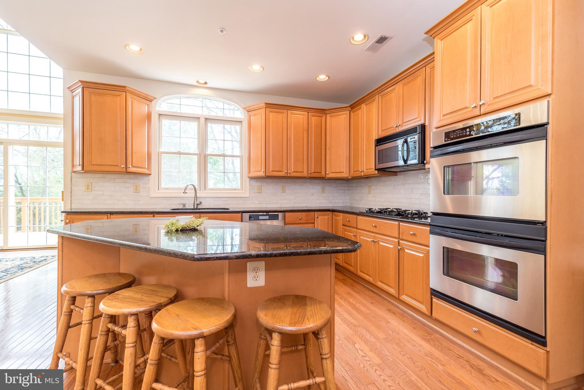 2517 Lockleigh Road Jamison, PA 18929 - Photo 30 of 72 a kitchen with stainless steel appliances granite countertop a stove a sink and a microwave