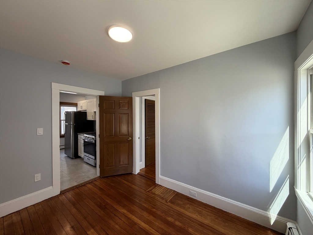 117 Merrymount Road, Unit 1 Quincy, MA 02169 - Photo 5 of 12 wooden floor in an empty room
