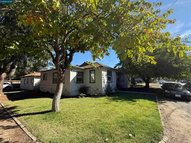 a front view of a house with a yard garden