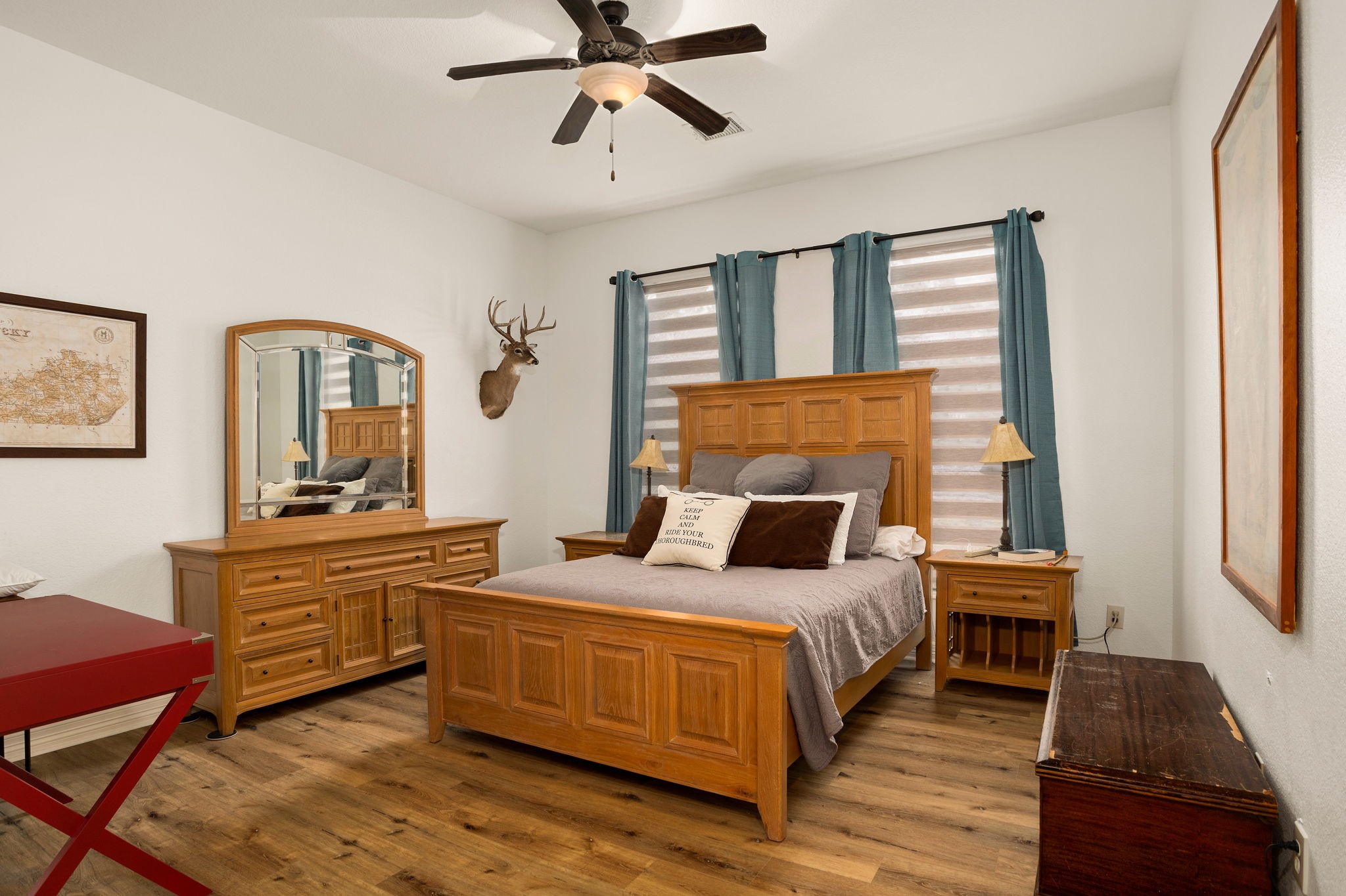 10210 Stidham Road Conroe, TX 77302 - Photo 21 of 39 a bedroom with a bed and wooden floor