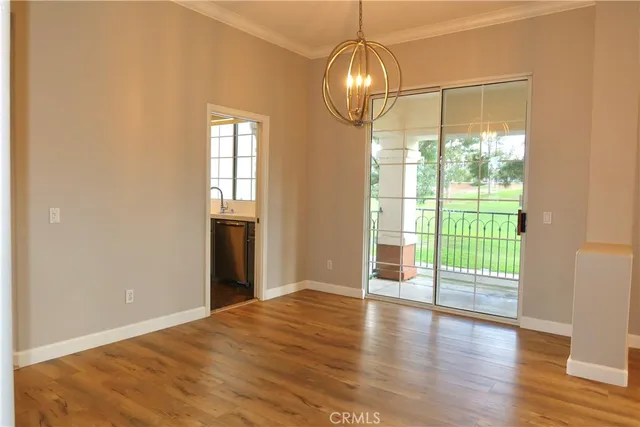 a view of an empty room with glass door and windows