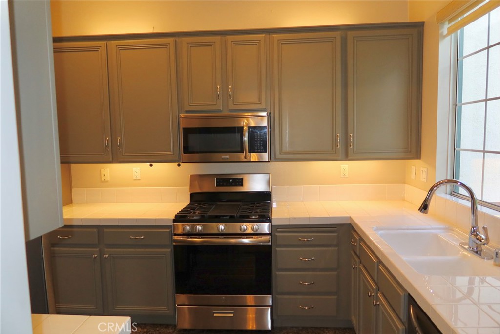 2827 Player Tustin, CA 92782 - Photo 26 of 42 a kitchen with stainless steel appliances a stove a microwave and a sink
