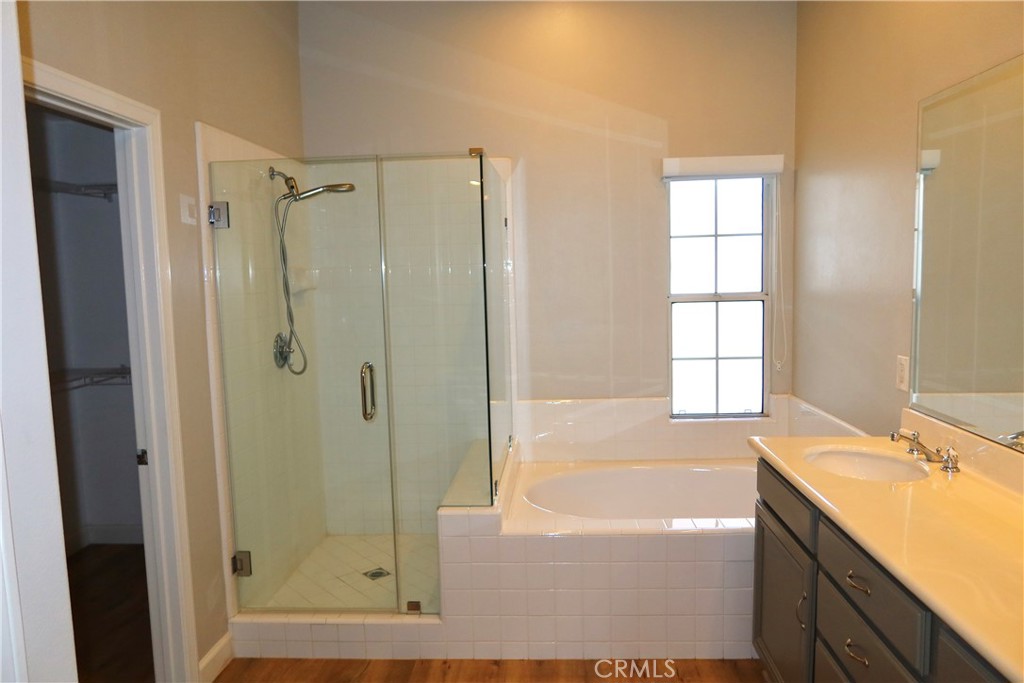2827 Player Tustin, CA 92782 - Photo 41 of 42 a bathroom with a granite countertop sink a mirror and a bathtub