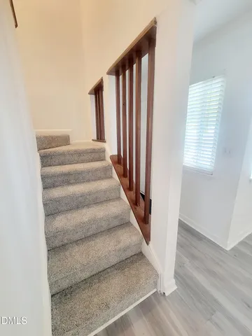 a view of staircase with white walls and a window