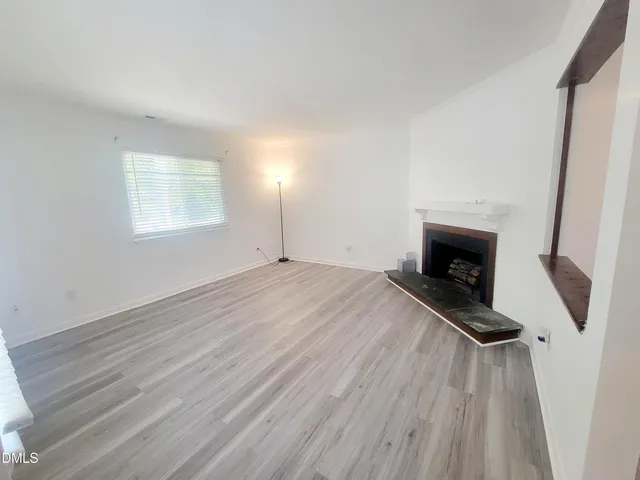 wooden floor in an empty room with a fireplace