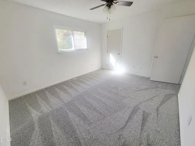 a view of a room with a ceiling fan