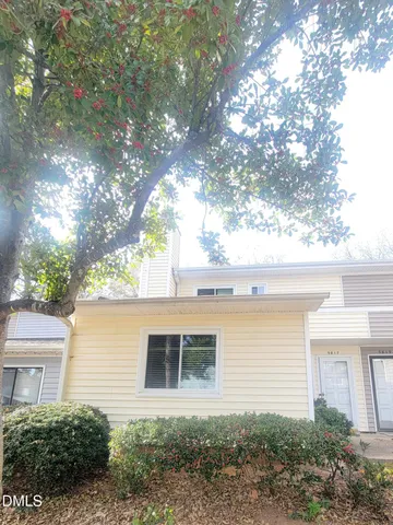 a backyard of a house with table and chairs