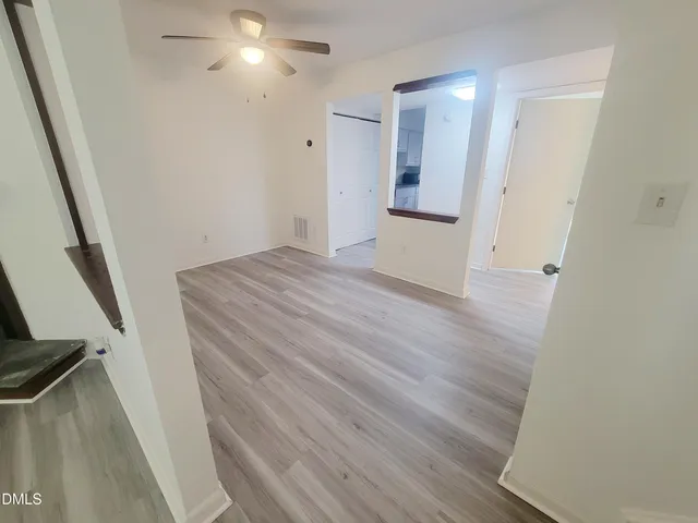 wooden floor in an empty room with a mirror