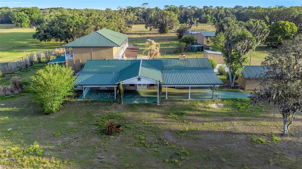 20138 Bowman Road Spring Hill, FL 34610 - Photo 4 of 40 an aerial view of a house with a yard table and chairs