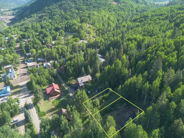 a backyard of a house with lots of green space and a fountain