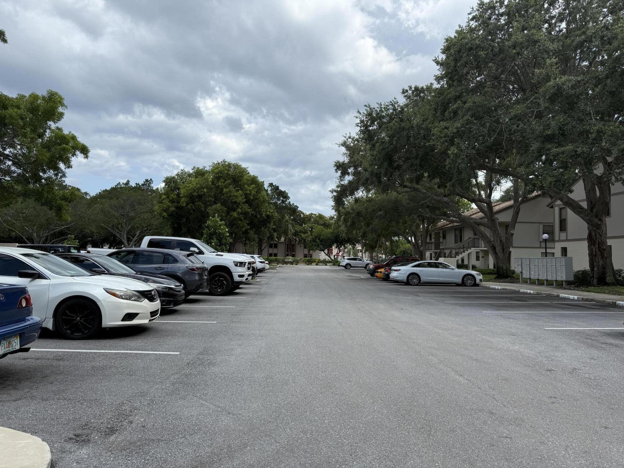 3130 Millwood Terrace, Unit 1110 Boca Raton, FL 33431 - Photo 18 of 18 a view of street with parked cars
