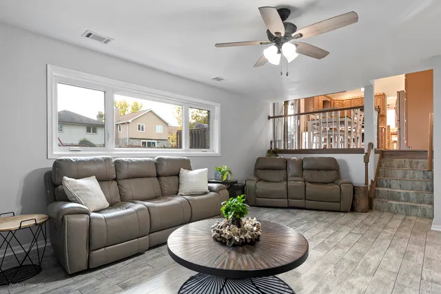 a living room with furniture and a chandelier