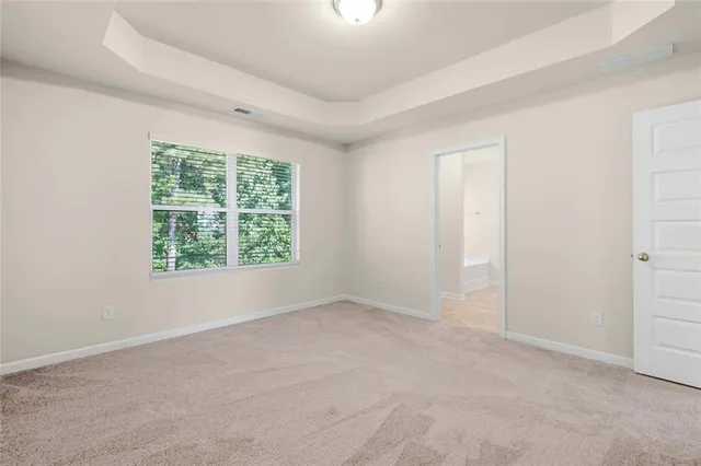a view of backyard with table and chairs and potted plants