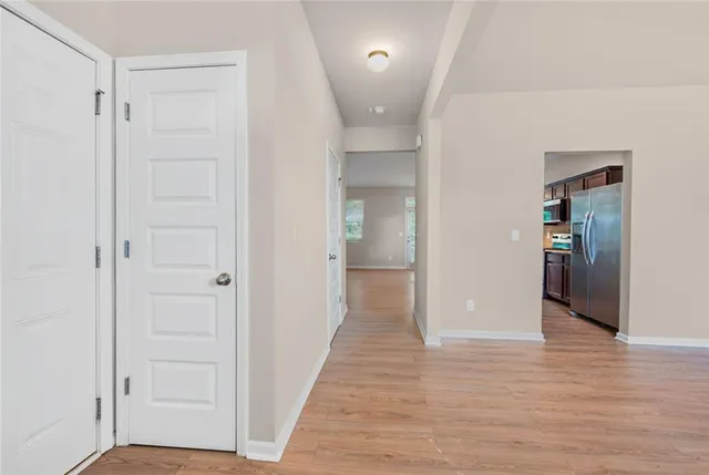 a view of a hallway with wooden floor