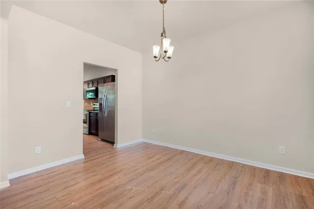 an empty room with wooden floor and fireplace