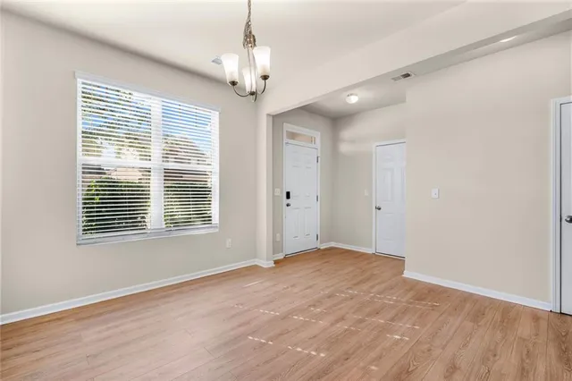 a view of an empty room with a fireplace and a window