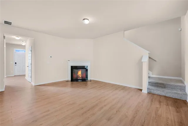 a large kitchen with stainless steel appliances granite countertop a stove a sink dishwasher and a refrigerator with wooden floor