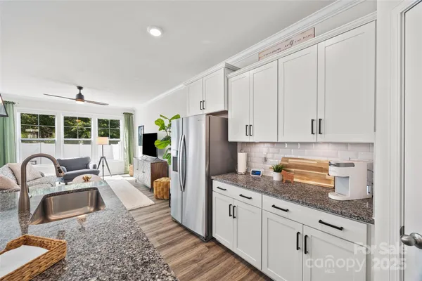 a kitchen with stainless steel appliances granite countertop a sink stove and refrigerator