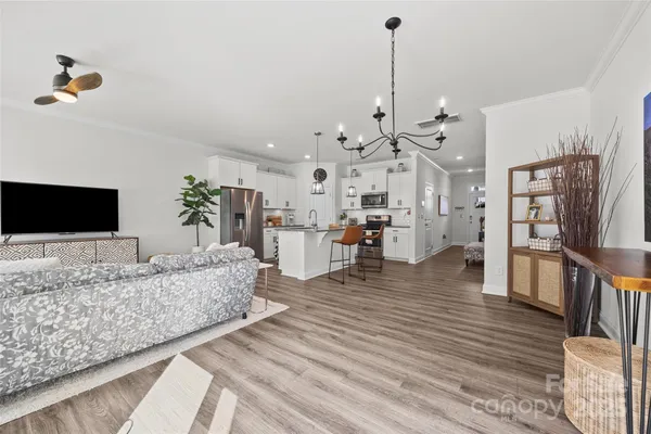 a living room with furniture and a chandelier
