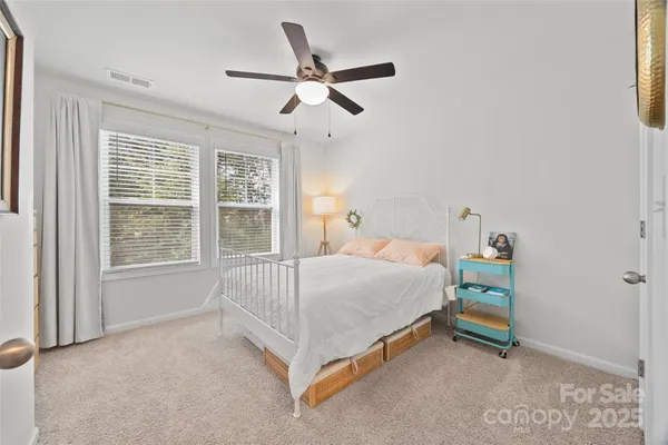 a bed sitting in a room next to a window